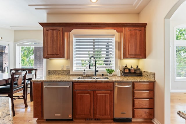 8708 E Redwood Ln, Spokane, WA 99217 - kitchen featuring light wood-style floors, light stone counters, stainless steel dishwasher, and brown cabinetry