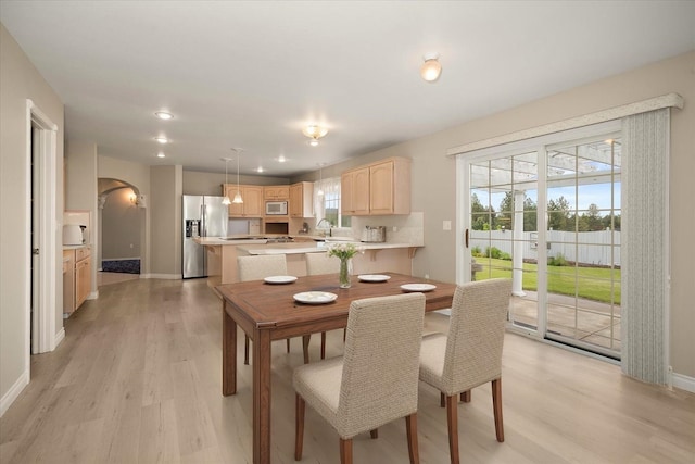 6419 W Skagit Ave, Spokane, WA 99208 - dining area featuring arched walkways, light wood finished floors, and recessed lighting