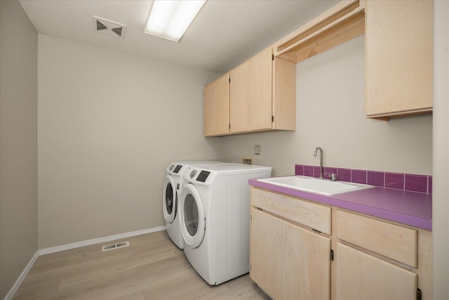 6419 W Skagit Ave, Spokane, WA 99208 - laundry area with cabinet space, independent washer and dryer, and light wood-type flooring