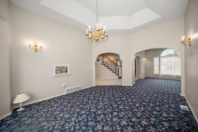 6419 W Skagit Ave, Spokane, WA 99208 - entrance foyer featuring arched walkways, a chandelier, carpet, stairs, and a high ceiling