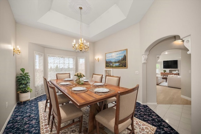 6419 W Skagit Ave, Spokane, WA 99208 - dining space with arched walkways, a chandelier, and light tile patterned floors