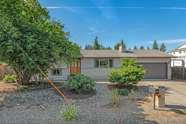 13908 E 32nd Ave, Spokane Valley, WA 99037 - view of front facade with brick siding, a garage, a chimney, concrete driveway, and roof with shingles