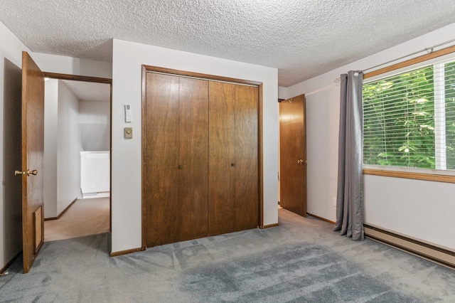 13908 E 32nd Ave, Spokane Valley, WA 99037 - unfurnished bedroom with carpet flooring, a closet, baseboard heating, and a textured ceiling