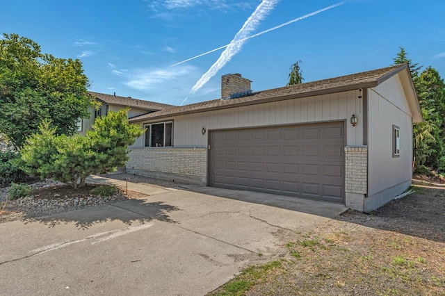 13908 E 32nd Ave, Spokane Valley, WA 99037 - view of front of home featuring brick siding, a chimney, an attached garage, and driveway