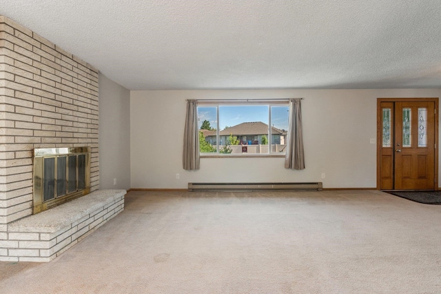 13908 E 32nd Ave, Spokane Valley, WA 99037 - unfurnished living room featuring a textured ceiling, a baseboard radiator, carpet flooring, and a fireplace