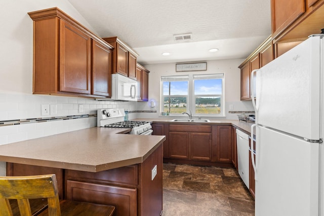 19020 E Euclid Ave, Otis Orchards, WA 99037 - kitchen featuring white appliances, a peninsula, decorative backsplash, recessed lighting, and stone finish flooring