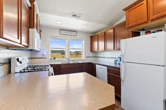 19020 E Euclid Ave, Otis Orchards, WA 99037 - kitchen with white appliances, recessed lighting, backsplash, a peninsula, and brown cabinetry