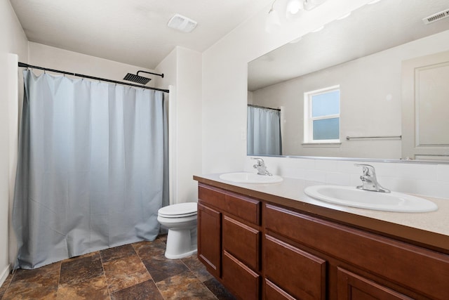 19020 E Euclid Ave, Otis Orchards, WA 99037 - bathroom with double vanity, stone finish floors, and a shower with shower curtain