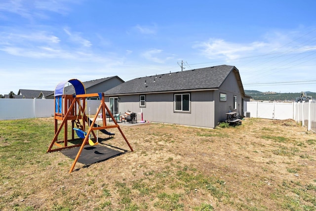 19020 E Euclid Ave, Otis Orchards, WA 99037 - rear view of property with a fenced backyard, a patio, roof with shingles, and a playground