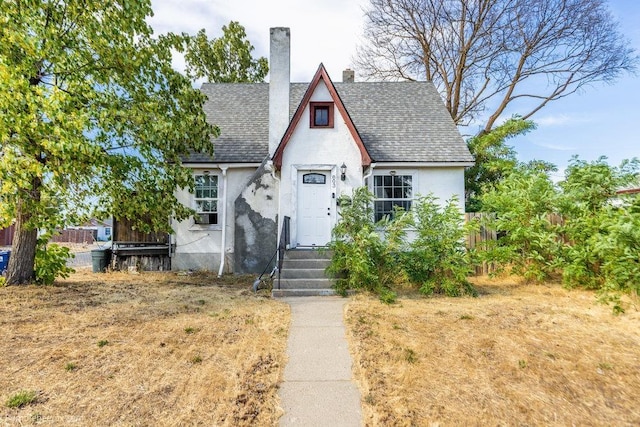 803 E Queen Ave, Spokane, WA 99207 - tudor home with stucco siding, a shingled roof, and a chimney