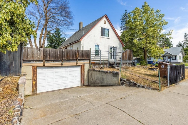 803 E Queen Ave, Spokane, WA 99207 - view of front of property with stucco siding and driveway