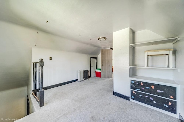 803 E Queen Ave, Spokane, WA 99207 - unfurnished living room with vaulted ceiling, radiator, and carpet floors