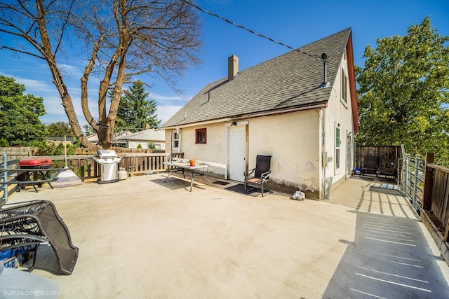 803 E Queen Ave, Spokane, WA 99207 - rear view of property with stucco siding, a shingled roof, a chimney, and a patio