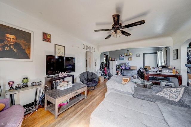 803 E Queen Ave, Spokane, WA 99207 - living room with arched walkways, ceiling fan, and light wood finished floors