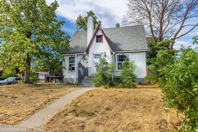 803 E Queen Ave, Spokane, WA 99207 - tudor home with stucco siding, a chimney, and a shingled roof