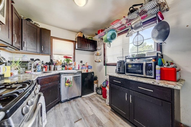 803 E Queen Ave, Spokane, WA 99207 - kitchen featuring stainless steel appliances, healthy amount of natural light, light wood-style floors, and dark brown cabinetry