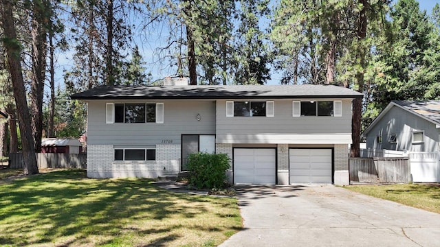 13709 E 30th Ave, Spokane Valley, WA 99216 - split foyer home featuring brick siding, an attached garage, and concrete driveway