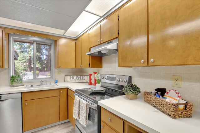 13709 E 30th Ave, Spokane Valley, WA 99216 - kitchen featuring stainless steel range with electric cooktop, under cabinet range hood, dishwashing machine, light countertops, and tasteful backsplash
