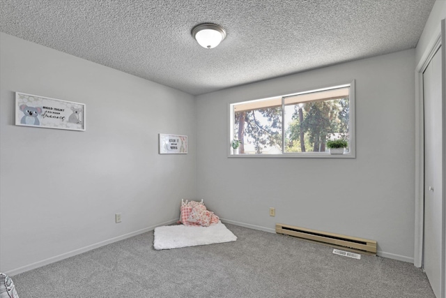 13709 E 30th Ave, Spokane Valley, WA 99216 - unfurnished bedroom with a baseboard heating unit, carpet, a textured ceiling, and a closet