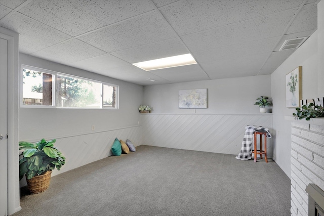13709 E 30th Ave, Spokane Valley, WA 99216 - below grade area with carpet floors, a wainscoted wall, and a drop ceiling