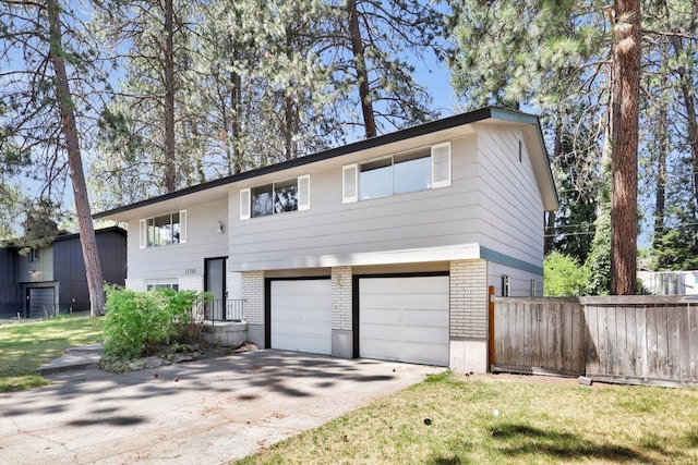 13709 E 30th Ave, Spokane Valley, WA 99216 - bi-level home featuring brick siding, an attached garage, and driveway