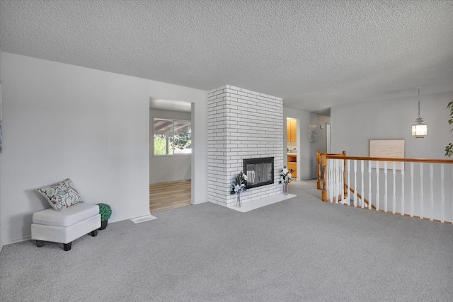13709 E 30th Ave, Spokane Valley, WA 99216 - unfurnished room featuring carpet, a textured ceiling, an upstairs landing, and a fireplace
