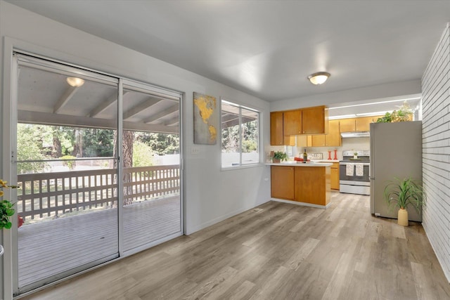 13709 E 30th Ave, Spokane Valley, WA 99216 - kitchen featuring appliances with stainless steel finishes, light wood-type flooring, a peninsula, and light countertops