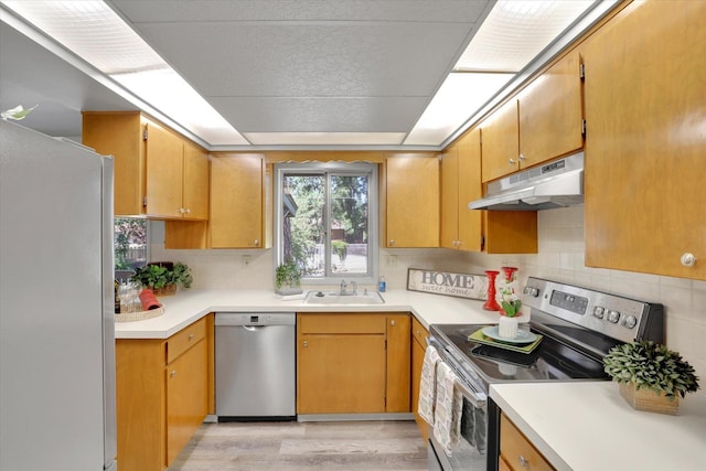 13709 E 30th Ave, Spokane Valley, WA 99216 - kitchen with stainless steel appliances, under cabinet range hood, healthy amount of natural light, and light wood finished floors