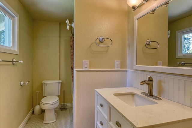 1428 E 18th Ave, Spokane, WA 99203 - full bathroom featuring vanity, a wainscoted wall, and tile patterned flooring