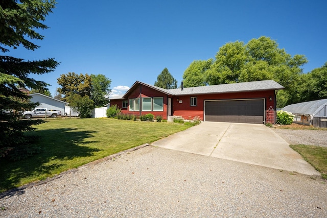 447 E Dakota Ave, Hayden, ID 83835 - ranch-style home with an attached garage, driveway, and a front lawn