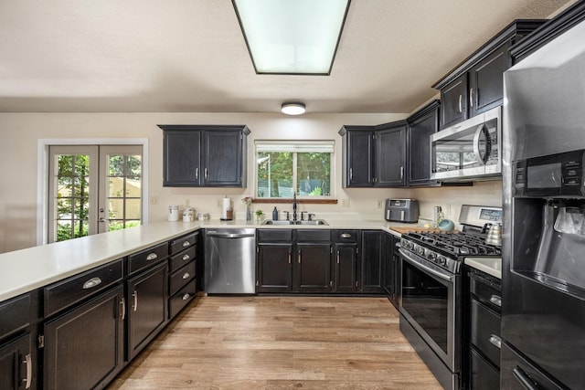 447 E Dakota Ave, Hayden, ID 83835 - kitchen featuring stainless steel appliances, healthy amount of natural light, light countertops, and light wood-style flooring