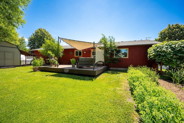 447 E Dakota Ave, Hayden, ID 83835 - rear view of house featuring a storage unit, a lawn, a wooden deck, and outdoor lounge area