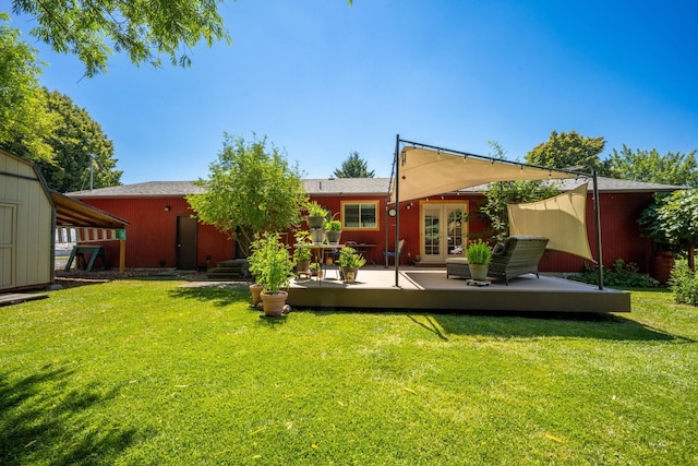447 E Dakota Ave, Hayden, ID 83835 - rear view of property featuring french doors, a wooden deck, a lawn, and a storage unit
