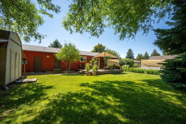 447 E Dakota Ave, Hayden, ID 83835 - view of green lawn featuring a deck and an outdoor structure