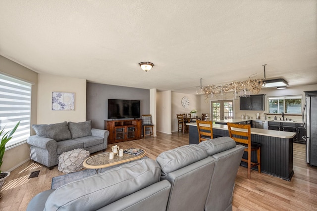 447 E Dakota Ave, Hayden, ID 83835 - living area featuring light wood finished floors and a textured ceiling