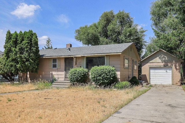 1647 E Decatur Ave, Spokane, WA 99208 - single story home with an outdoor structure, concrete driveway, a chimney, a detached garage, and a shingled roof