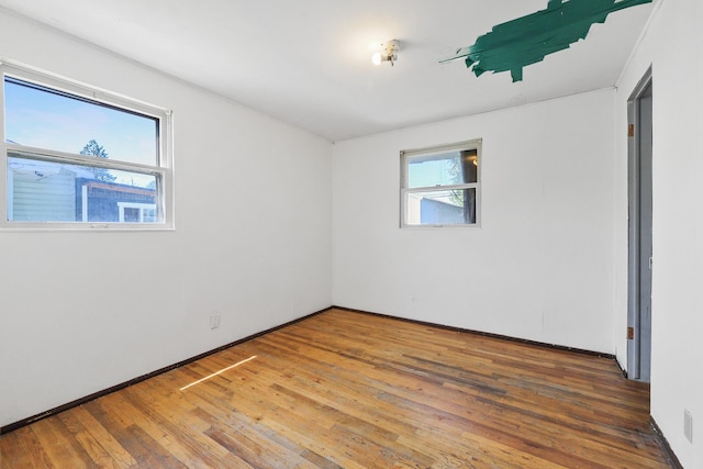 1647 E Decatur Ave, Spokane, WA 99208 - empty room with wood finished floors and baseboards