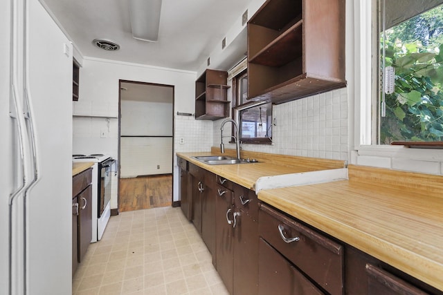 1647 E Decatur Ave, Spokane, WA 99208 - kitchen featuring white appliances, open shelves, dark brown cabinetry, decorative backsplash, and light floors