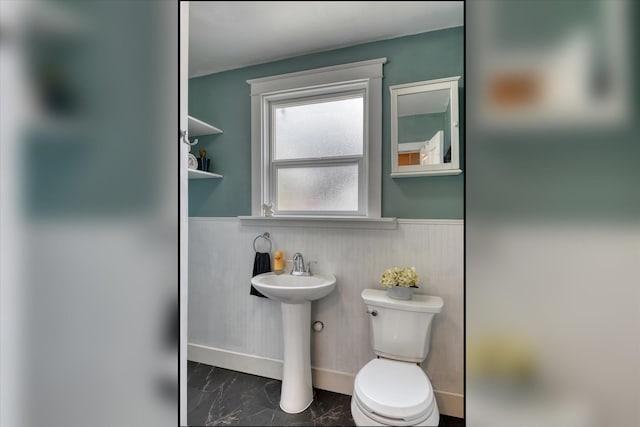 703 E Lacrosse Ave, Spokane, WA 99207 - bathroom with wainscoting and marble look tile flooring