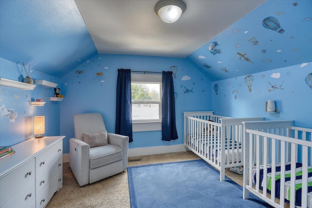 703 E Lacrosse Ave, Spokane, WA 99207 - bedroom featuring vaulted ceiling, carpet floors, and a nursery area