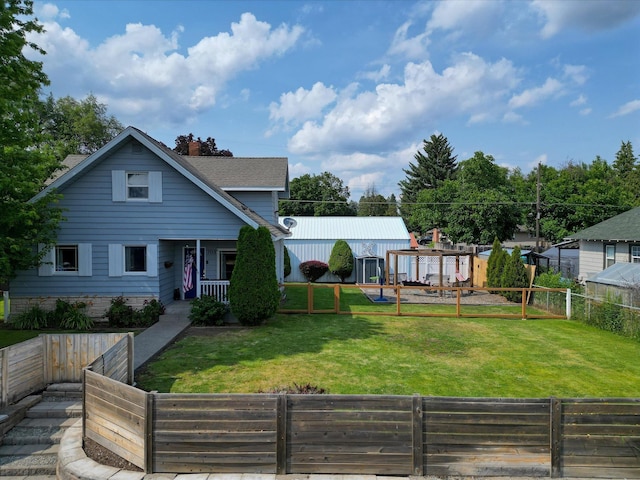 703 E Lacrosse Ave, Spokane, WA 99207 - view of front of house with a fenced backyard, a chimney, and covered porch