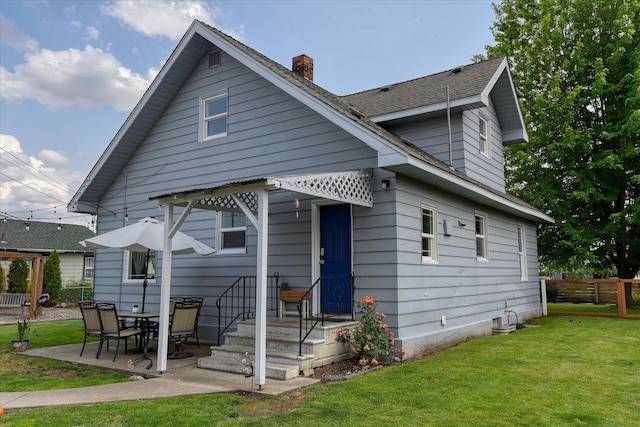 703 E Lacrosse Ave, Spokane, WA 99207 - back of house featuring a chimney, a patio area, and roof with shingles