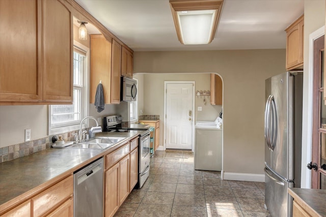 703 E Lacrosse Ave, Spokane, WA 99207 - kitchen with stainless steel appliances, independent washer and dryer, light brown cabinets, and light tile patterned floors