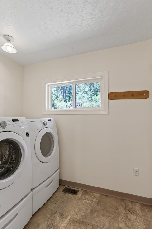 17221 N Little Spokane Dr, Colbert, WA 99005 - laundry room with washing machine and dryer, plenty of natural light, and a textured ceiling
