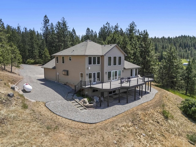 17607 E Judkins Rd, Spokane, WA 99217 - back of property with a forest view, a wooden deck, and stairway