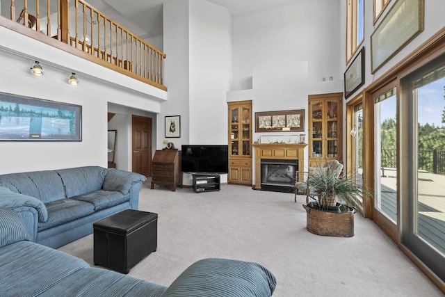 17607 E Judkins Rd, Spokane, WA 99217 - carpeted living area featuring a towering ceiling and a glass covered fireplace