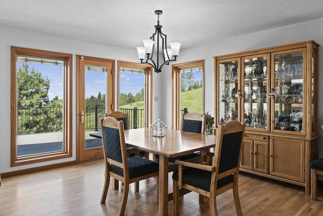 17607 E Judkins Rd, Spokane, WA 99217 - dining space with a chandelier, light wood finished floors, and plenty of natural light