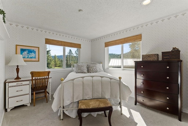 996A Basin Rd, Colville, WA 99114 - bedroom with multiple windows, light carpet, a textured ceiling, and wallpapered walls