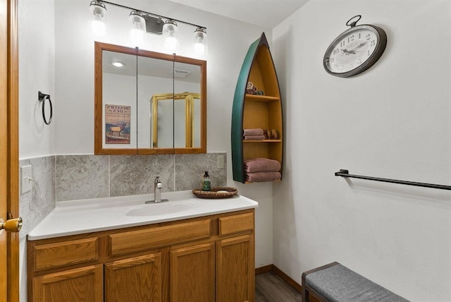 996A Basin Rd, Colville, WA 99114 - bathroom featuring vanity, backsplash, and wood finished floors