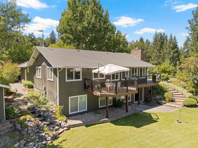 996A Basin Rd, Colville, WA 99114 - back of property with a wooden deck, a chimney, a lawn, and roof with shingles
